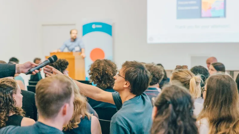 Man reaching for a microphone