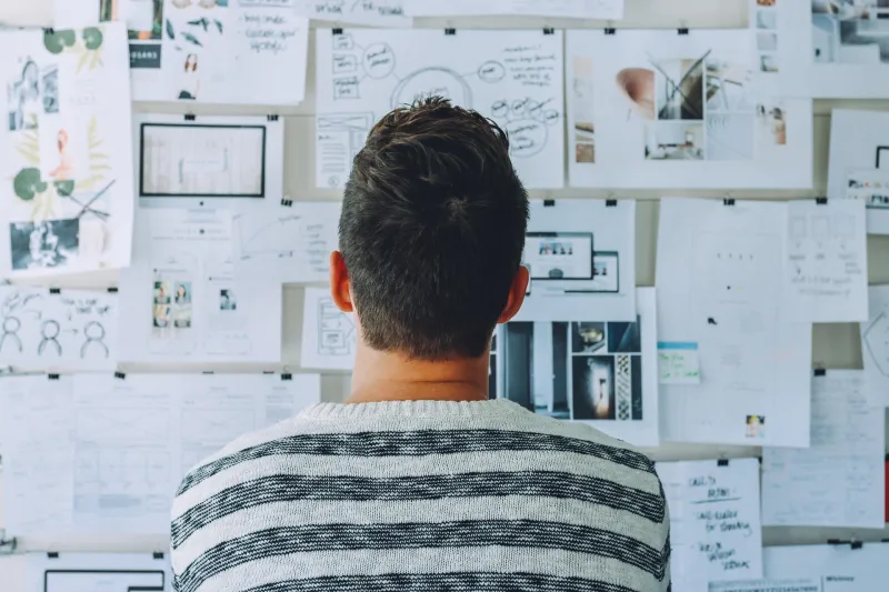 Man in front of a board