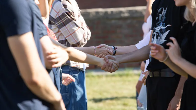 Students holding hands