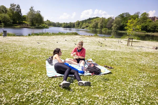 Students at the lake in Louvain-la-Neuve