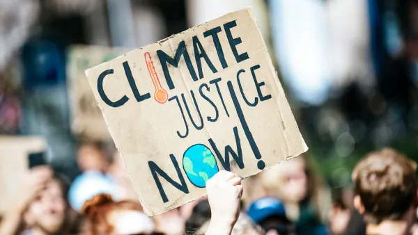 A protester with a sign saying "Climate justice now!"
