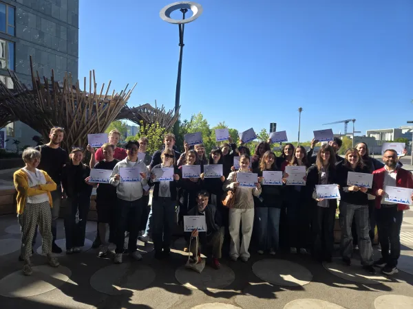 Group shot of students posing with their participation certificates at the end of the summer school.